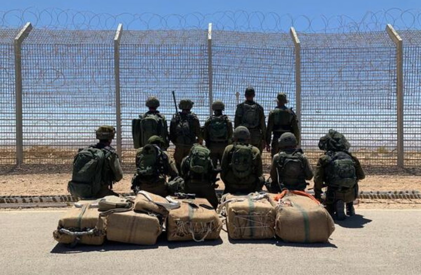 IDF soldiers posing with the 105kg. of drugs caught on May 25, 2022 (credit: IDF SPOKESPERSON'S UNIT)