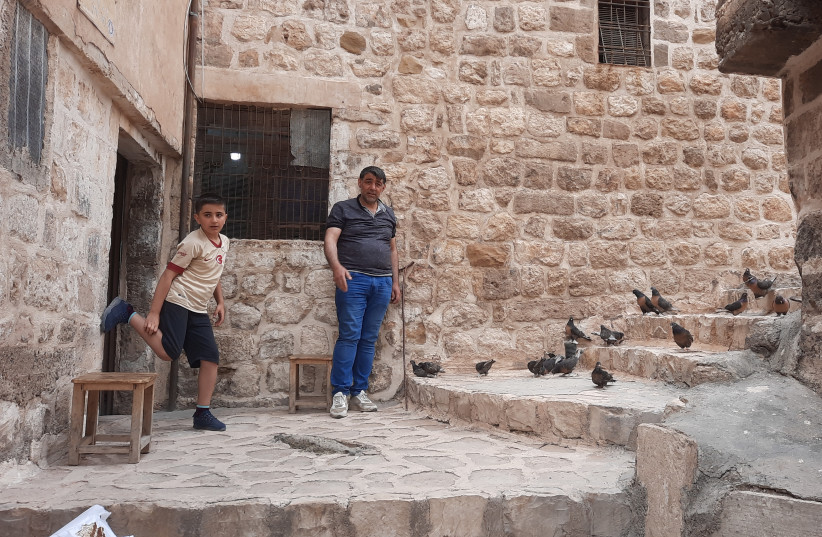 Mardin pigeon trainer Murat Yel and son Murataz ''It is in my roots.'' (credit: JUDITH SUDILOVSKY)