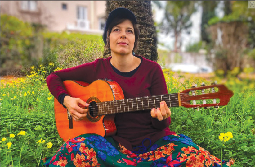  STRUMMING A guitar in her new homeland. (credit: Eitan Ben Avraham)