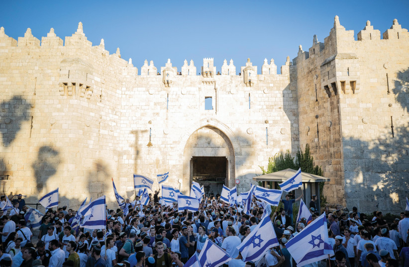  ISRAELIS DANCE with flags outside the Damascus Gate in Jerusalem’s Old City during the Flag March last year. (credit: YONATAN SINDEL/FLASH90)