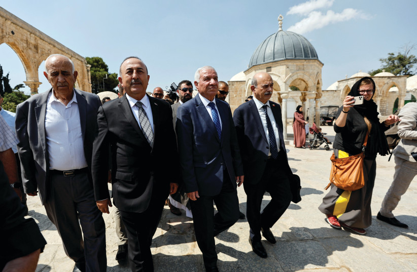  TURKISH FOREIGN Minister Mevlut Cavusoglu visits the compound that houses Al-Aqsa Mosque in Jerusalem’s Old City, Wednesday. (photo credit: AMMAR AWAD/REUTERS)