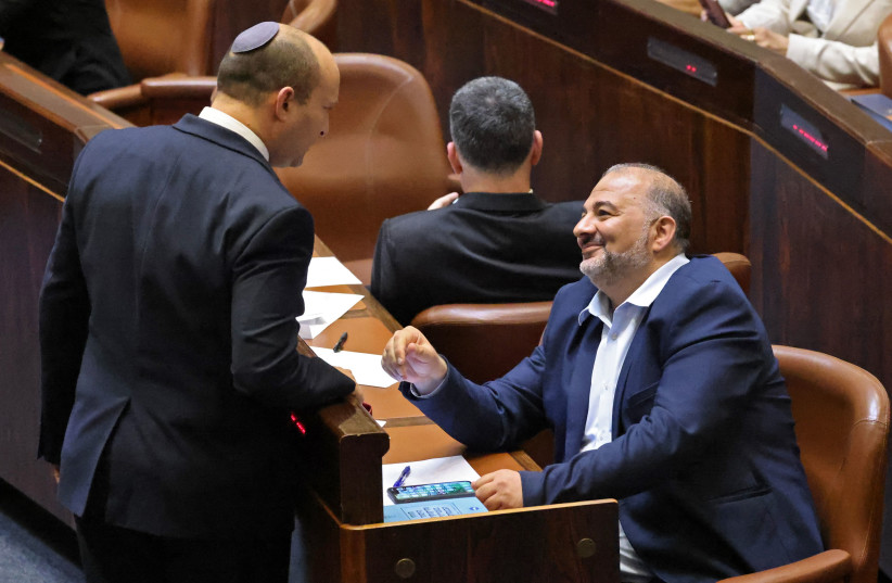  Naftali Bennett and Mansour Abbas in the Knesset.  (photo credit: Emmanuel Dunand/AFP via Getty Images)