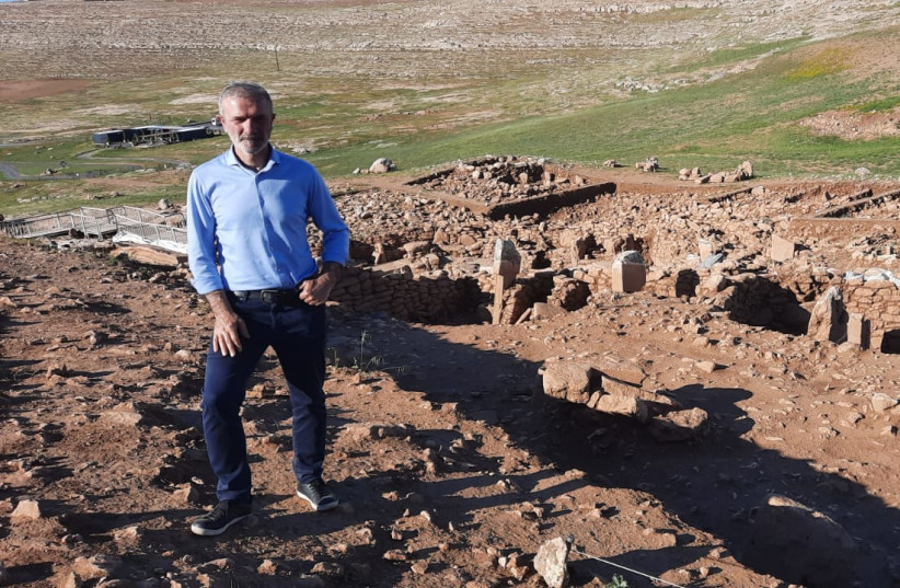  Archaeology professer and director of the Göbeklitepe Culture and Karahantepe Research Project in front of Karahantepe excavation site. (photo credit: JUDITH SUDILOVSKY)