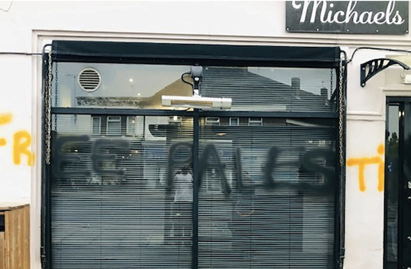  The words "free Palestine" were spray-painted on the facade of a cafe owned by an Israeli in London, May 14, 2022. (photo credit: MICHAEL LEVI via JTA)