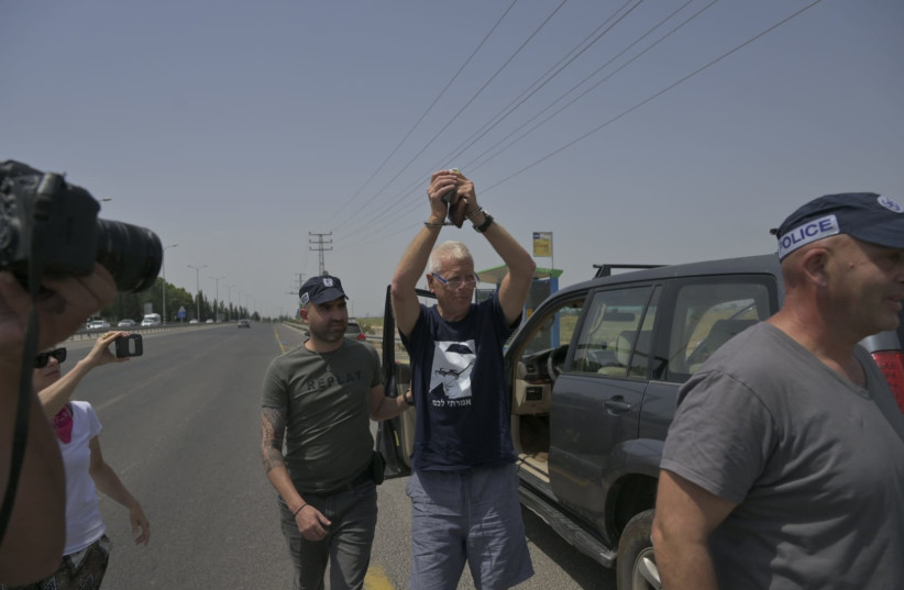 Left-wing activist Yishai Hadas is arrested by police after allegedly plotting to raze Homesh with a rented bulldozer, on May 28, 2022. (credit: PEACE NOW)