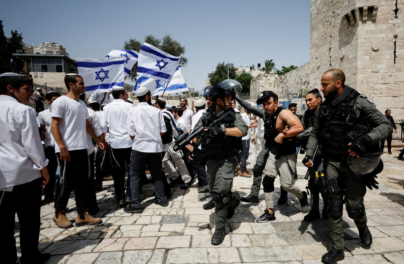  Israeli Border police detain a Palestinian man during clashes near Damascus gate to Jerusalem's Old City on Jerusalem Day, May 29, 2022.  (credit: AMMAR AWAD/REUTERS)