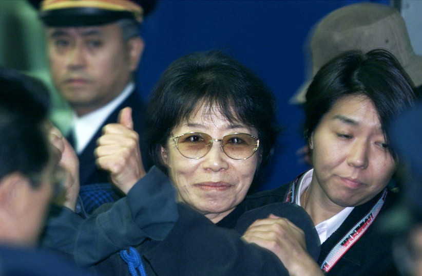  Leftist Japanese Red Army leader Fusako Shigenobu (C), surrounded by police, raises handcuffed hands upon arrival at Tokyo Station following her arrest in Osaka, western Japan November 8, 2000. Three decades of dodging international law enforcement authorities came to an end for the Red Army leader (credit: REUTERS)