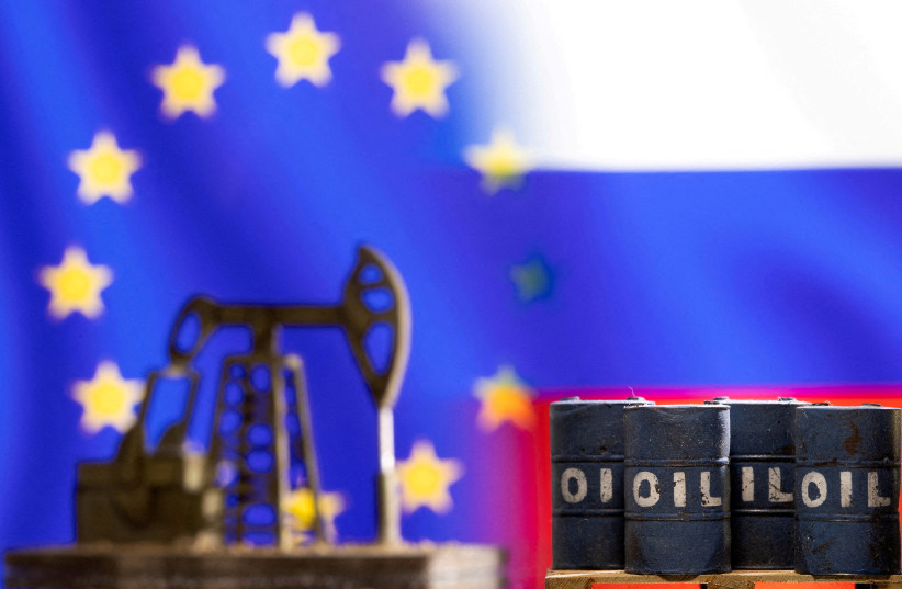  Models of oil barrels and a pump jack are seen in front of displayed EU and Russia flag colours in this illustration taken March 8, 2022. (photo credit: REUTERS)