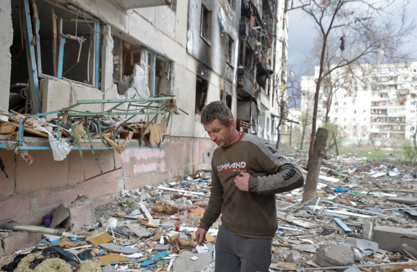  Local resident Viacheslav walks on debris of a residential building damaged by a military strike, as Russia's attack on Ukraine continues, in Sievierodonetsk, Luhansk region, Ukraine April 16, 2022 (credit: REUTERS/SERHII NUZHNENKO)