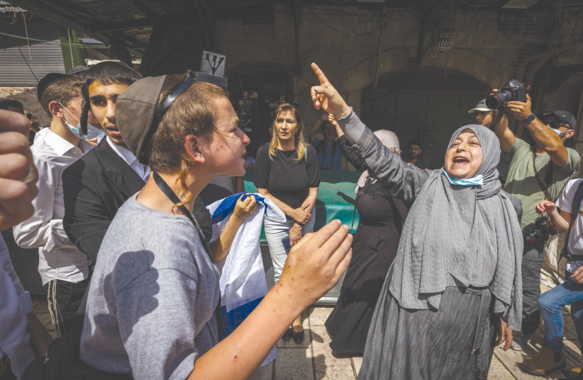 A MUSLIM WOMAN confronts Jewish youth during a Jerusalem Day celebration in the Muslim Quarter of the Old City on Sunday. (photo credit: OLIVIER FITOUSSI/FLASH90)