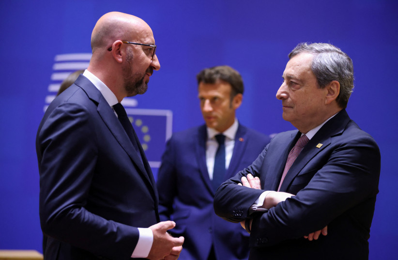 European Council President Charles Michel, Italy's Prime Minister Mario Draghi and France's President Emmanuel Macron attend the European Union leaders summit, as EU's leaders attempt to agree on Russian oil sanctions in response to Russia's invasion of Ukraine, in Brussels, Belgium, May 30, 2022. (photo credit:  REUTERS/JOHANNA GERON)