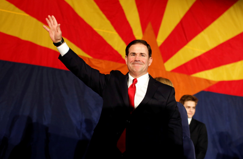 Arizona Gov. Doug Ducey greets the GOP midterm elections watch party after being re-elected in Phoenix, Arizona, US, November 6, 2018. (credit: REUTERS/NICOLE NERI)