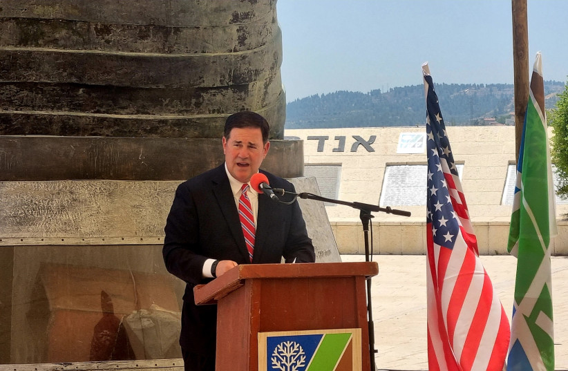 Arizona Gov. Doug Ducey speaks at the Memorial Day event at the 9/11 Living Memorial in Arazim Valley, Jerusalem, May 30, 2022. (photo credit: MAYA MARGIT/THE MEDIA LINE)
