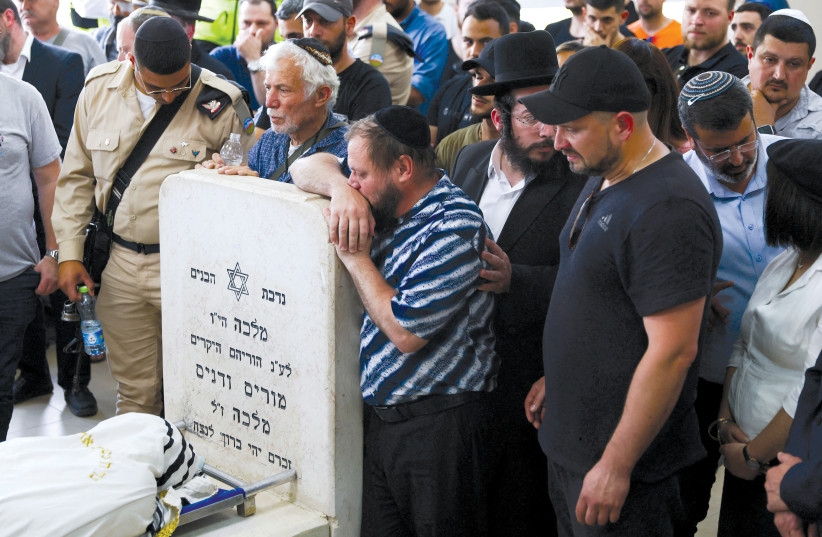  Family and friends mourn at the funeral in Beit Shemesh on May 1 of Vyacheslav Golev, a 23-year-old security guard who was gunned down by two terrorists at the entrance to Ariel on April 29.  (credit: RONEN ZVULUN/REUTERS)