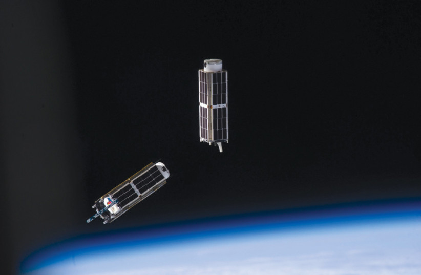 An illustration of nanosatellites floating in space above the Earth’s atmosphere.  (credit: NASA)