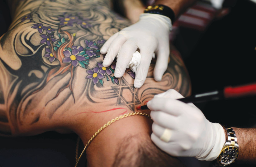  HALACHA PROHIBITS all forms of unnecessary bodily harm, such as tattoos. (photo credit: TOMER NEUBERG/FLASH90)