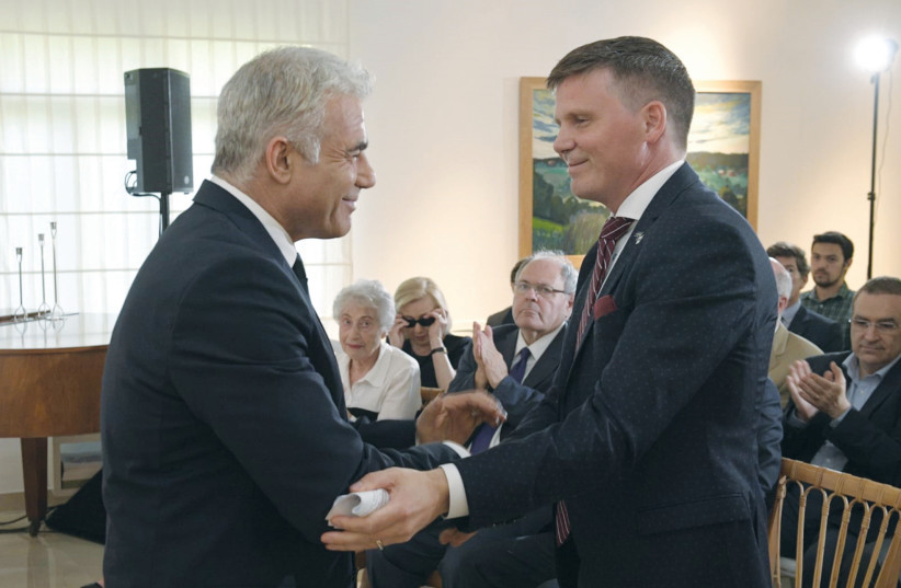  FOREIGN MINISTER Yair Lapid is greeted by Swedish Ambassador Erik Ullenhag.  (photo credit: COURTESY FOREIGN MINISTRY)
