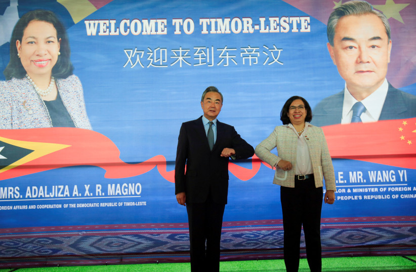  Chinese Foreign Minister Wang Yi bumps elbows with East Timor's Minister of Foreign Affairs and Cooperation Adaljiza Magno during their meeting in Dili, East Timor, June 3, 2022 (credit: REUTERS/LIRIO DA FONSECA)