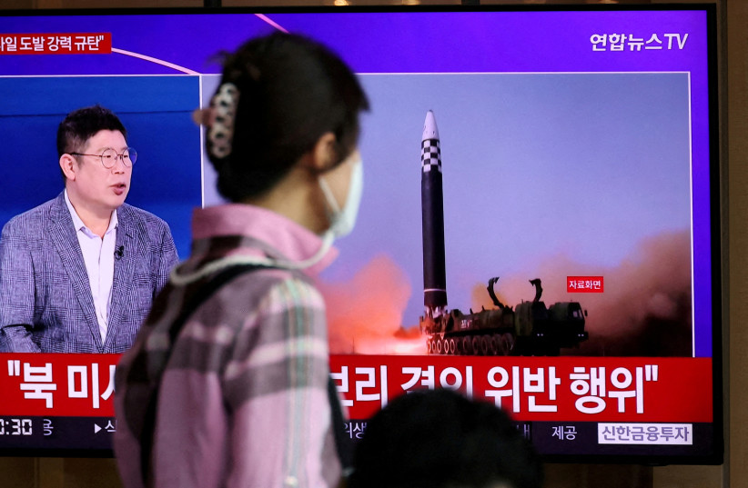 A woman watches a TV broadcasting a news report on North Korea's launch of three missiles including one thought to be an intercontinental ballistic missile (ICBM), in Seoul, South Korea, May 25, 2022. (photo credit: REUTERS/KIM HONG-JI TPX IMAGES OF THE DAY/FILE PHOTO)