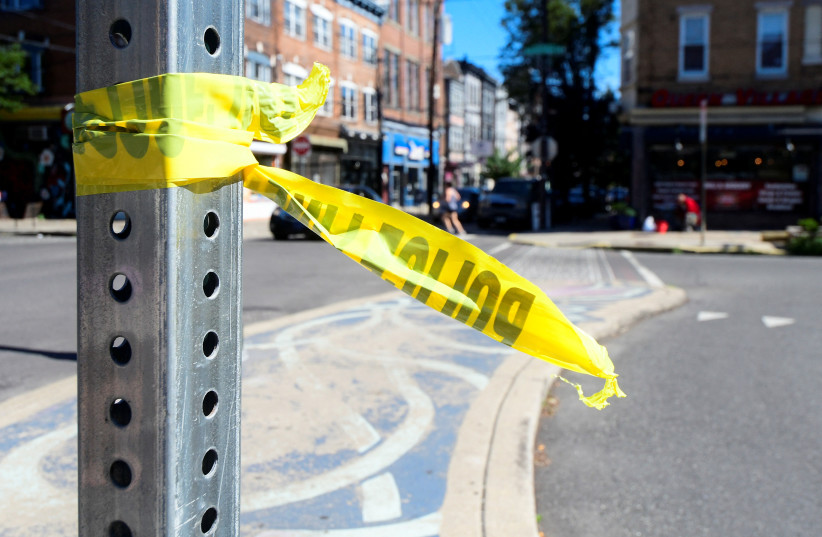  Police tape is pictured at a crime scene after a deadly mass shooting on South Street in Philadelphia, Pennsylvania, US, June 5, 2022. (credit: REUTERS/BASTIAAN SLABBERS)