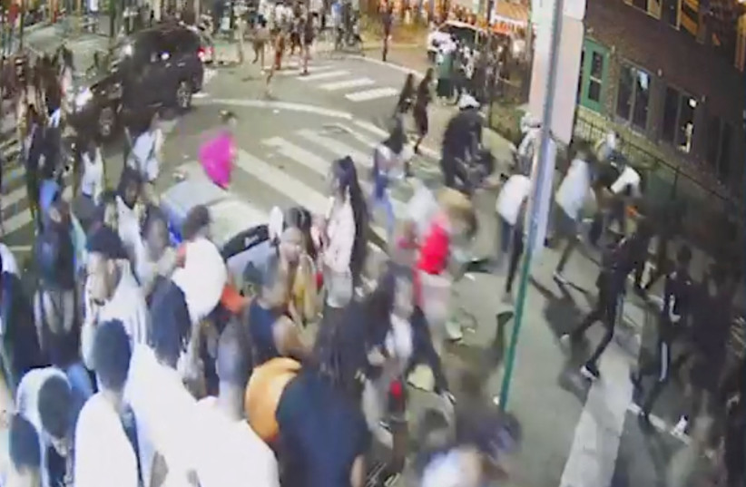  A screen grab from a surveillance video from the shooting shows people on a crowded street running in panic, presumably after gun shots were fired, in Philadelphia, Pennsylvania. (credit: South Street CCTV/Handout via REUTERS)