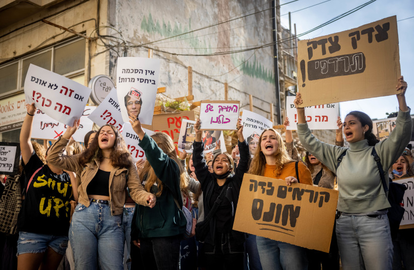   Israeli activist protest against Yuval Carmi, a psychologist suspected of committing sexual offenses and in support of Kim Ariel Arad who is one of the alleged victims of Yuval Carmi, in Jerusalem, October 24, 2021. (photo credit: YONATAN SINDEL/FLASH90)