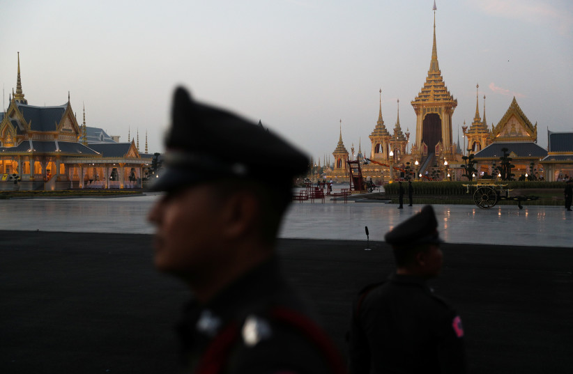  Police officers stand guard before the start of the funeral procession for Thailand's late King Bhumibol Adulyadej before the Royal Cremation Ceremony in front of the Grand Palace in Bangkok, Thailand, October 26, 2017 (photo credit: ATHIT PERAWONGMETHA / REUTERS)