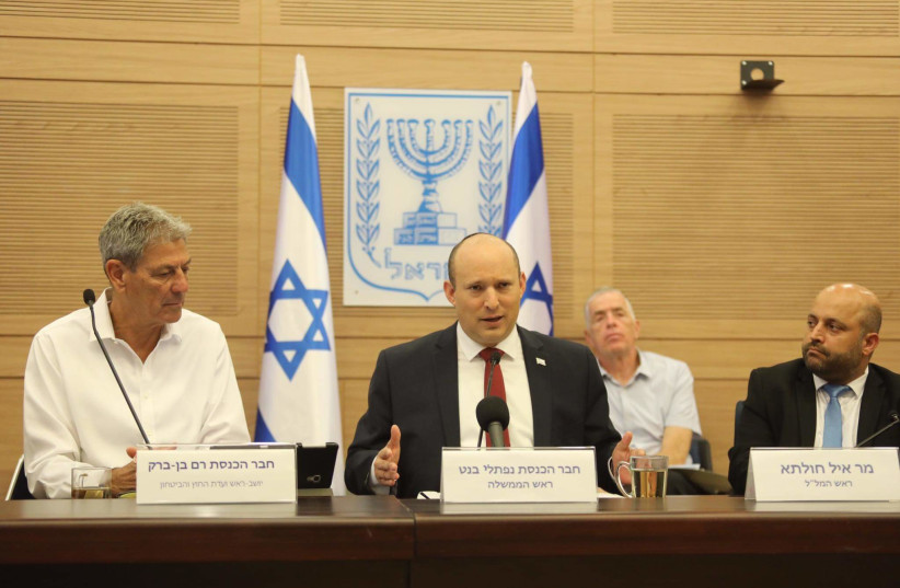  Prime Minister Naftali Bennett is seen alongside MK Ram Ben-Barak and National Security Adviser Eyal Hulata in the Knesset in Jerusalem, on June 7, 2022. (photo credit: MARC ISRAEL SELLEM/THE JERUSALEM POST)