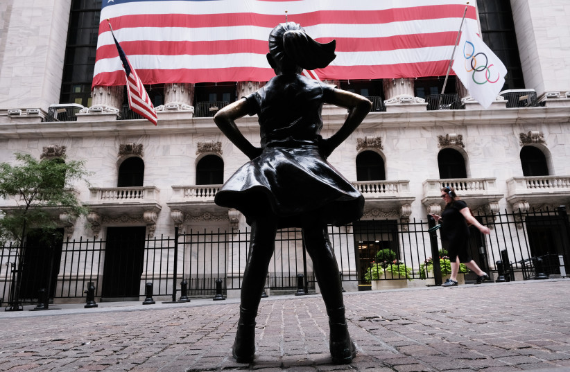  People walk by the Fearless Girl statue outside of the New York Stock Exchange on August 10, 2021, in New York.  (photo credit: SPENCER PLATT/GETTY IMAGES/TNS)