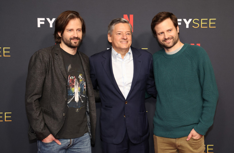  CEO of Netflix Ted Sarandos poses with show creators Matt and Ross Duffer at a special event for the television series "Stranger Things" at Raleigh Studios Hollywood in Los Angeles, California, US, May 27, 2022. (photo credit: REUTERS/MARIO ANZUONI)