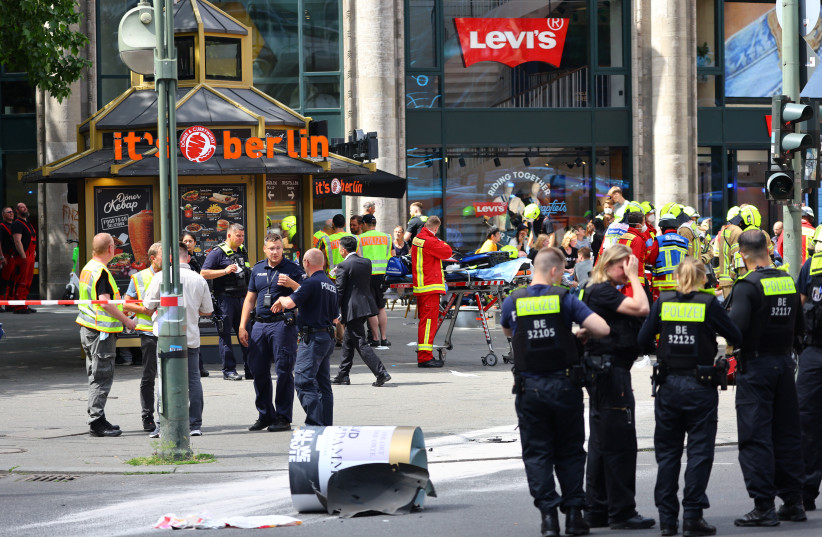 First responders work at the site after a car crashed into a group of people, injuring dozens and killing at least one, at Tauentzien Strasse near Kaiser Wilhelm Gedaedtniskirche church in Berlin, Germany June 8, 2022.  (credit: REUTERS/FABRIZIO BENSCH)