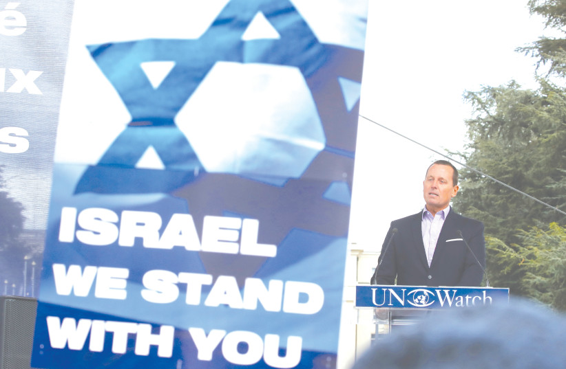 THEN-US Ambassador to Germany Richard Grenell attends a rally protesting anti-Israel bias outside the UN Human Rights Council in Geneva, in 2019.  (photo credit: DENIS BALIBOUSE/REUTERS)