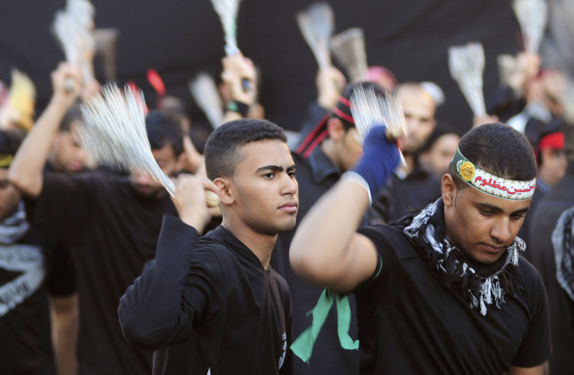  SHI’ITE WORSHIPERS beat their chests during the Ashura festival in Qatif, Saudi Arabia. Ashura, which falls on the 10th day of the Islamic month of Muharram, commemorates the death of Imam Hussein, grandson of Prophet Mohammad, who was killed in the 7th-century battle of Kerbala.  (photo credit: Zaki Ghawas/Reuters)
