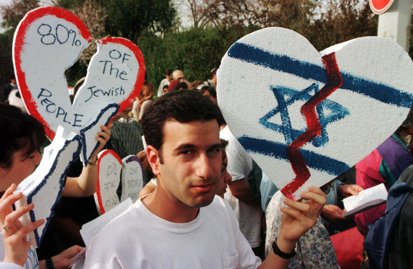  REFORM JEWS hold up broken hearts as they demonstrate outside the Knesset in 1997 against pending legislation by ultra-religious parties to tighten their grip on conversion issues.  (photo credit: REUTERS)