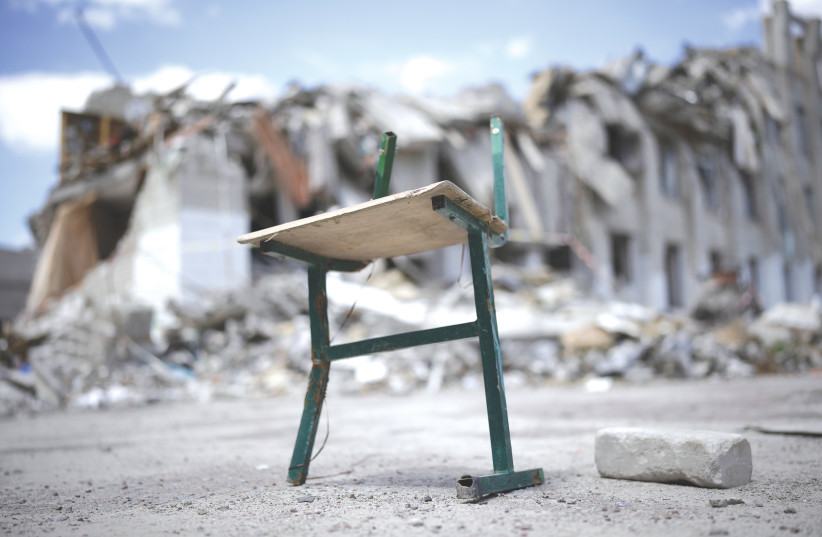  A SCHOOL chair litters the remains of the bombed Lyceum No. 25 School in Zhytomyr, Ukraine, earlier this week. The school was hit by a Russian cruise missile in early March and waits to be rebuilt or demolished. (photo credit: Christopher Furlong/Getty Images)