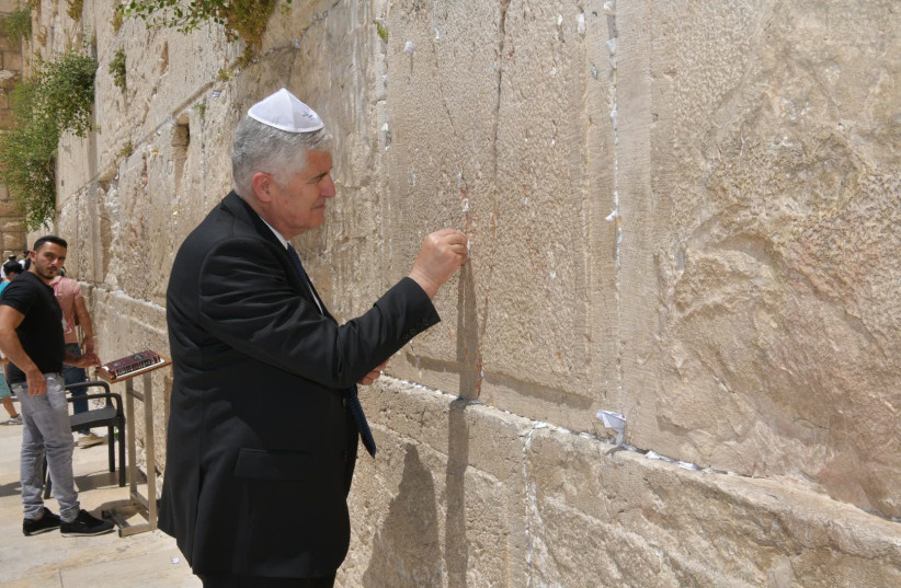   The tall diplomat stood before the Western Wall on Wednesday, wearing a white skullcap, and placed a prayer for peace between its ancient stones. (photo credit: SHLOMI AMSALEM)