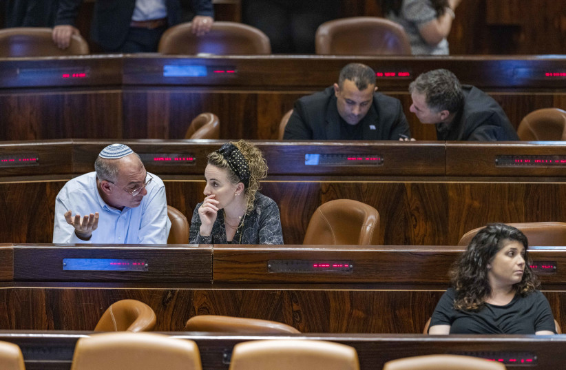  MKs Nir Orbach and Idit Silman talk during a vote on the "Flag Bill" at the Knesset on June 1, 2022.  (photo credit: OLIVIER FITOUSSI/FLASH90)