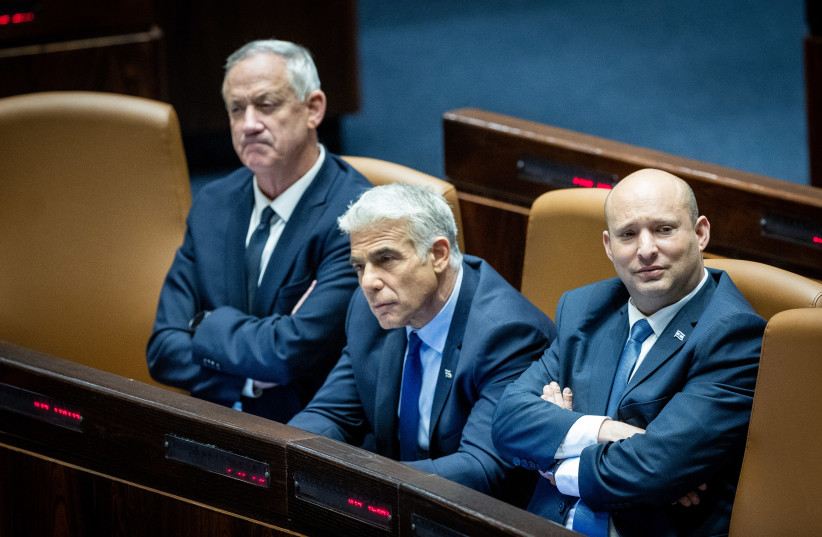 Israeli prime minister Naftali Bennett, Minister of Foreign Affairs Yair Lapid and Minister of Defense Benny Gantz attend a plenum session in the assembly hall of the Knesset, the Israeli parliament in Jerusalem on May 23, 2022. (photo credit: YONATAN SINDEL/FLASH90)
