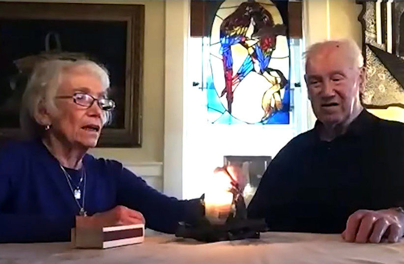  Fred Manasse, a child Holocaust survivor, and his wife Annette light a candle last month at Boston’s Yom Hashoah virtual gathering in memory of Herbert Karliner, one of the last survivors of the ill-fated SS St. Louis ship of Jewish refugees from Nazi Germany. (photo credit: Courtesy of theJewish Community Relations Council of Greater Boston)