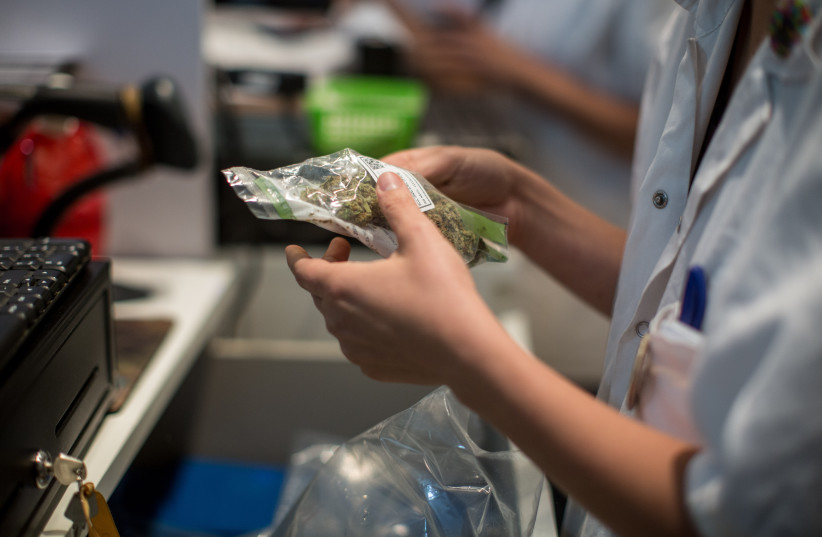  Pharmicists supply patients with prescribed medical marijuana at the 'Tikun Olam' store in Tel Aviv, on April 10, 2016.  (credit: HADAS PARUSH/FLASH90)
