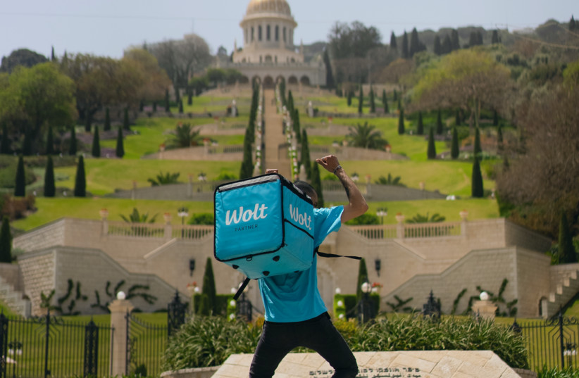  A Wolt courier takes flight before the fabled Baha'i Gardens. (photo credit: Wolt Israel PR)