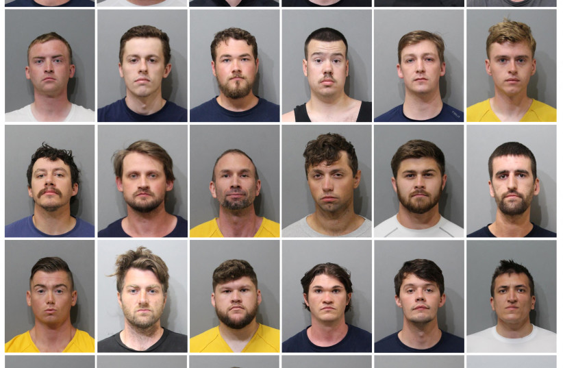  Thirty men, who police say are affiliated with the white nationalist group Patriot Front, pose for jail booking photographs released by the Kootenai County Sheriff's Office in Coeur d'Alene, Idaho, U.S. June 12, 2022. The men and their leader (not shown) were arrested for conspiracy to riot. (photo credit: Kootenai County Sheriff's Office/Handout via REUTERS)