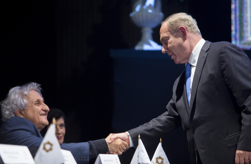  Israel's then-prime minister Benjamin Netanyahu shake hands with Israeli author A.B. Yehoshua during an award ceremony for the ''EMET Prize'' for excellence in academic and professional achievements in the arts, science and culture, held at the Jerusalem theatre on  December 4, 2016.  (credit: YONATAN SINDEL/FLASH90)