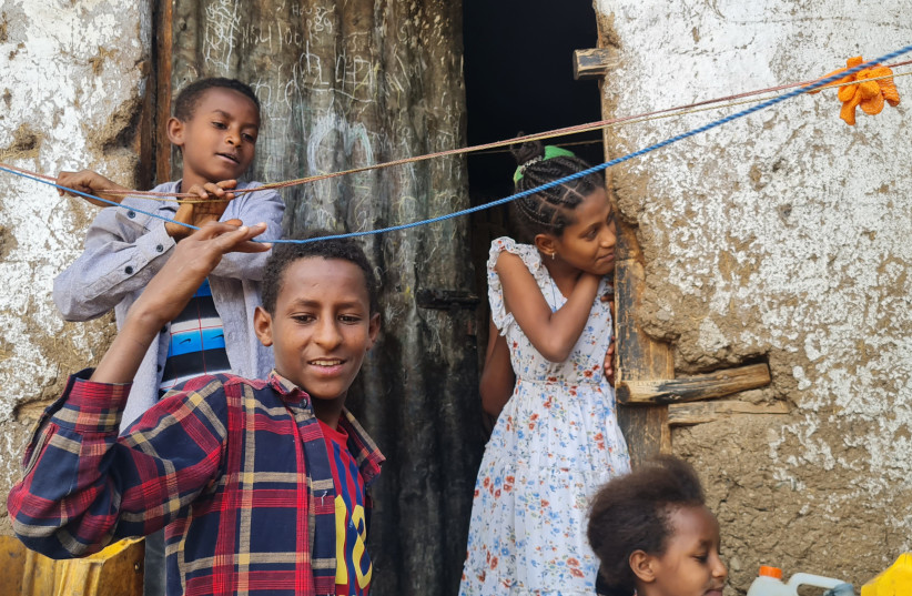  Children of Falash Mura children help hand the washing outside their home in Gondar, Ethiopia, May 29, 2022. (photo credit: CNAAN LIPHSHIZ/JTA)