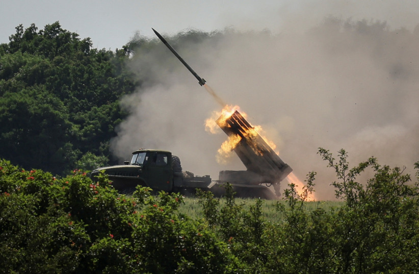 Ukrainian service members fire a BM-21 Grad multiple rocket launch system, near the town of Lysychansk, Luhansk region, amid Russia's attack on Ukraine, June 12, 2022. (credit: REUTERS/GLEB GARANICH)