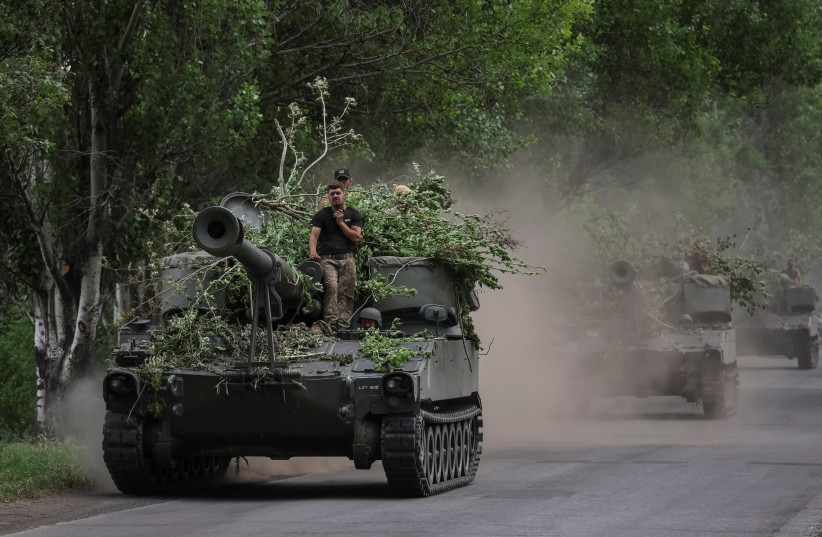 Ukrainian servicemen ride American 155 mm turreted self-propelled howitzers M109, amid Russia's attack on Ukraine, in Donetsk region, Ukraine, June 13, 2022. (photo credit: REUTERS/GLEB GARANICH)