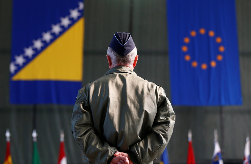  A member of European Forces (EUFOR) stands in front of the Bosnia and Herzegovina and European Union flags during Change of Command Ceremony in Sarajevo, Bosnia and Herzegovina March 28, 2017. (photo credit: REUTERS/DADO RUVIC)