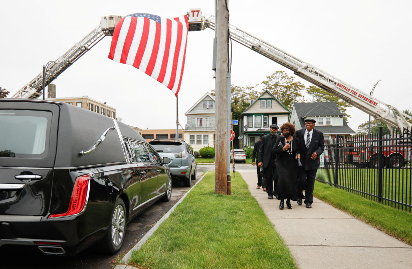  People walk past a hearse outside funeral for Buffalo shooting victim Ruth Whitfield who was shot and killed in the attack by an avowed white supremacist at Tops supermarket, in Buffalo, New York, US May 28, 2022.  (credit: REUTERS/Lindsay DeDario)