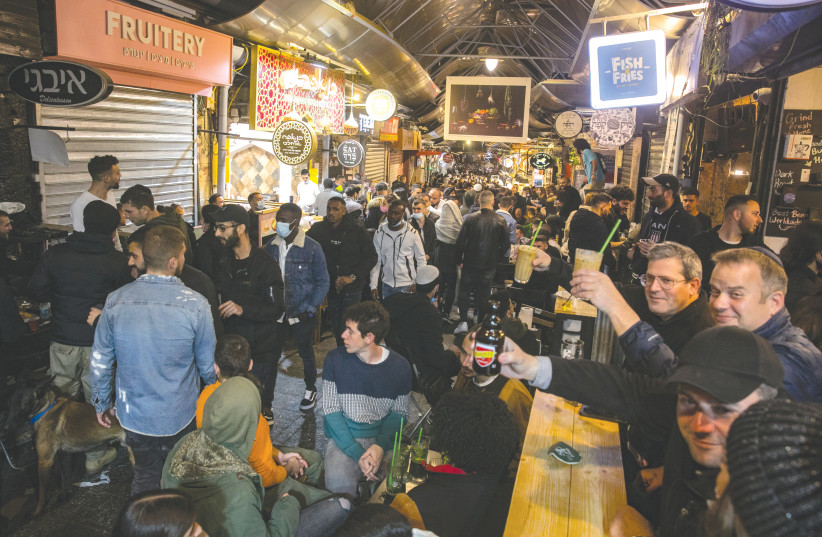  BARS AND restaurants do a brisk business at Mahaneh Yehuda in Jerusalem. Israel regularly ranks as one of the happiest nations on earth. (photo credit: OLIVIER FITOUSSI/FLASH90)