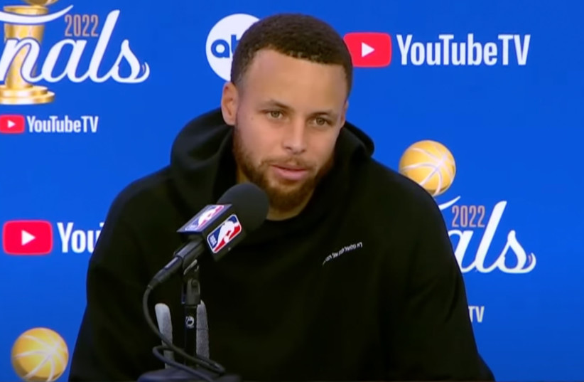  Stephen Curry sporting a sweatshirt with Hebrew on it during an NBA Finals postgame press conference, June 10, 2022.  (photo credit: SCREENSHOT FROM YOUTUBE/JTA)